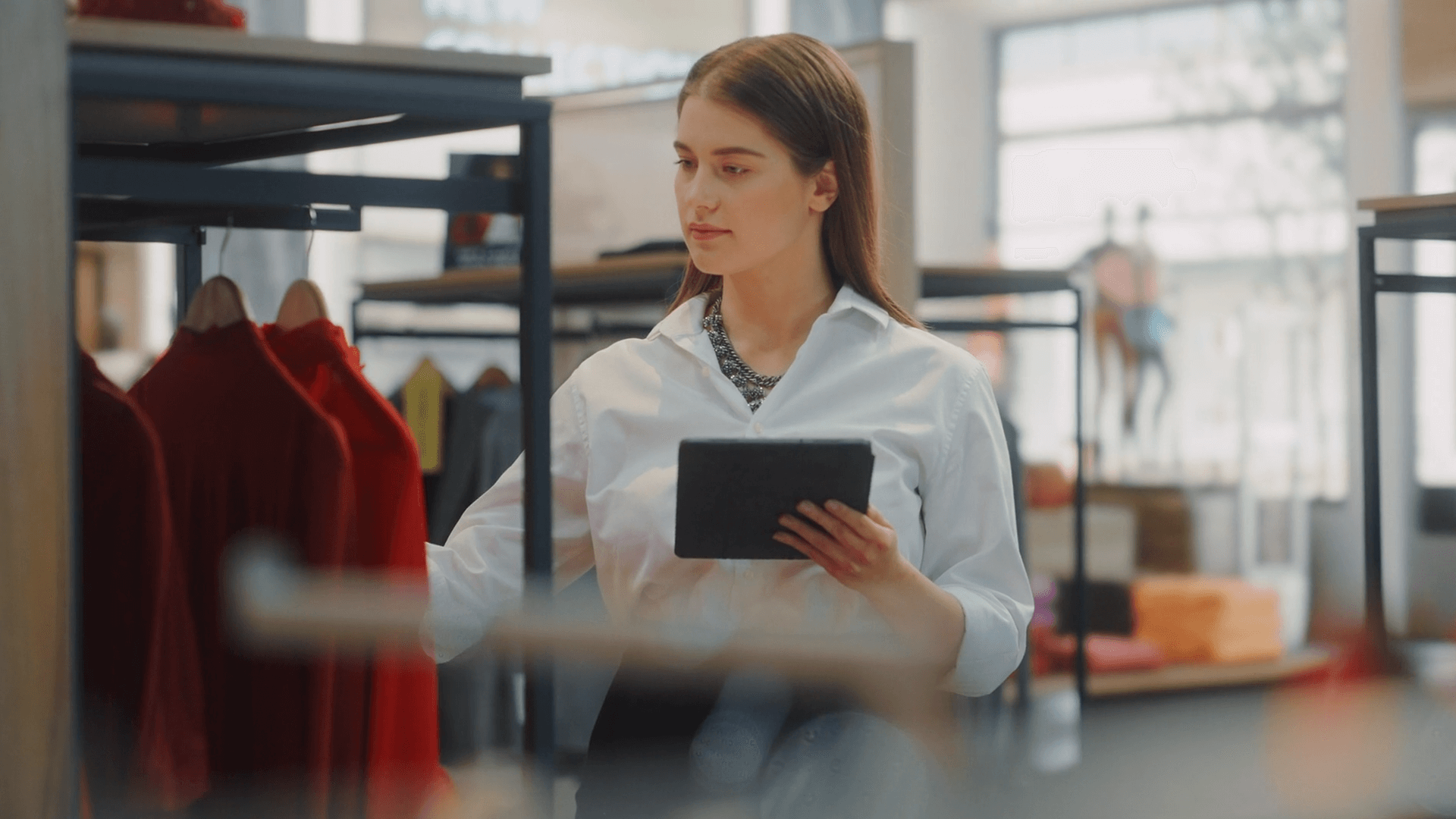 lady in store checking inventory with a tablet